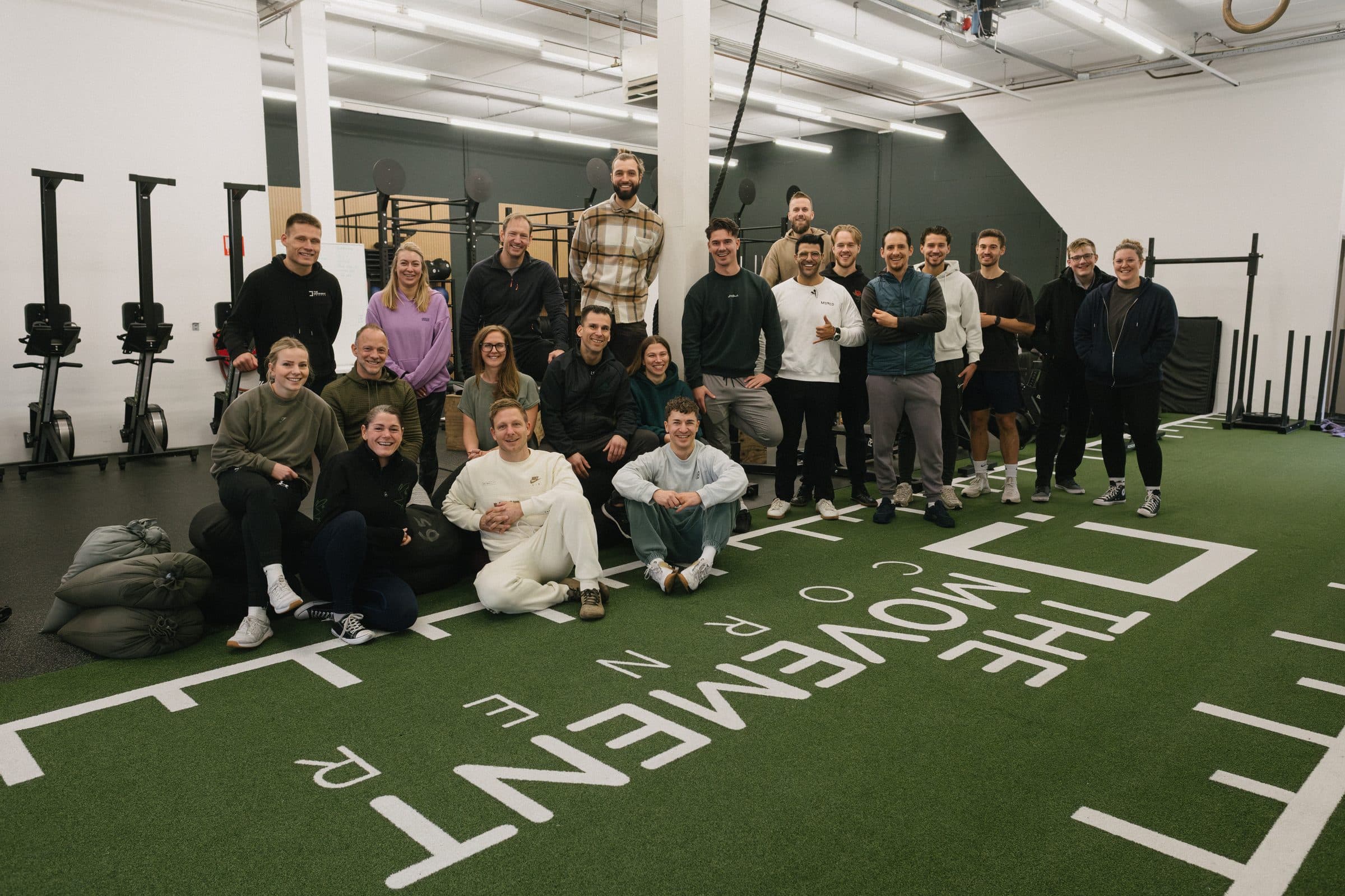 A full group of coaches and staff posing together after a Moved Academy seminar