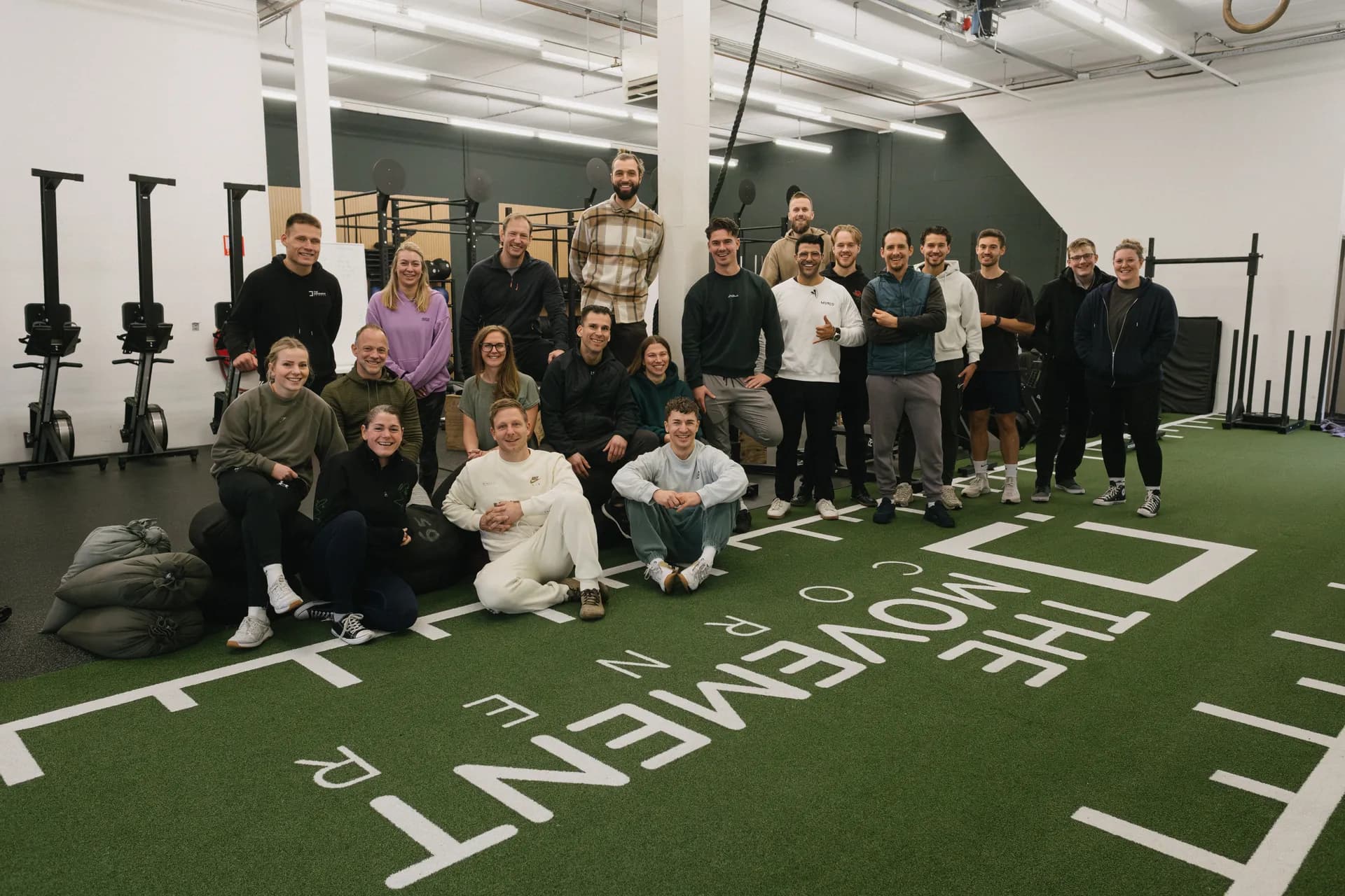 A full group of coaches and staff posing together after a Moved Academy seminar