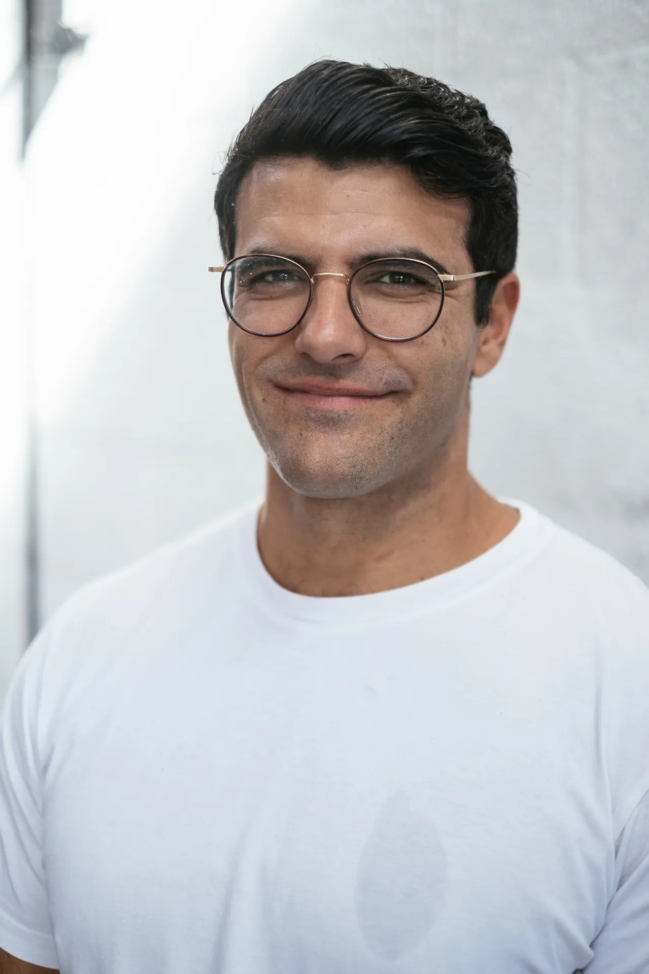Close portrait of Richard Aceves smiling gently, soft studio light