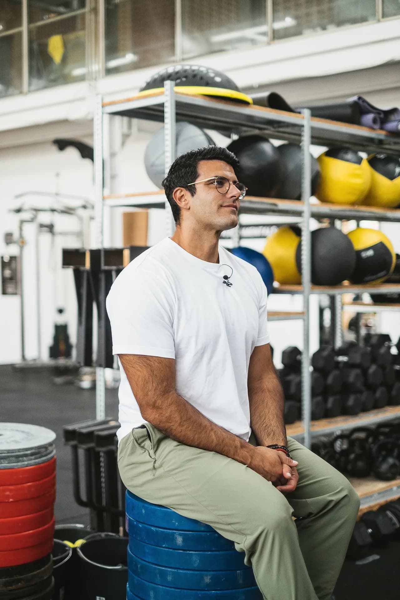 Richard Aceves seated among training equipment in a gym